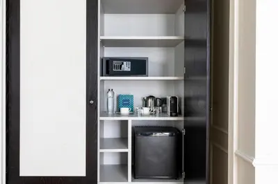 a cupboard with a microwave and a coffee maker at Maldà Singular Hotel in Barcelona