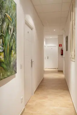 an empty hallway with a painting on the wall at Hostal Martinval in Barcelona