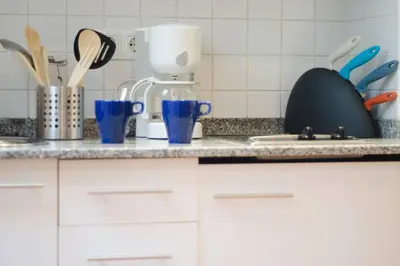 a kitchen counter with dishes and utensils on it at Ripoll Apartments in Barcelona