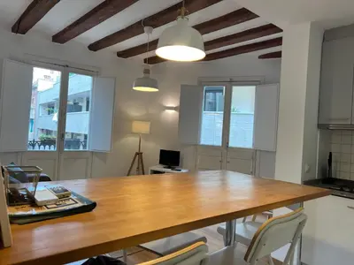 a dining room with a wooden table and chairs at Ripoll Apartments in Barcelona