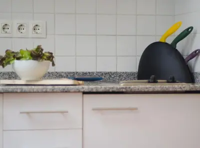 a kitchen counter with a sink and a bowl of vegetables at Ripoll Apartments in Barcelona