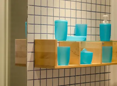 a shelf with blue cups on it in a bathroom at Ripoll Apartments in Barcelona