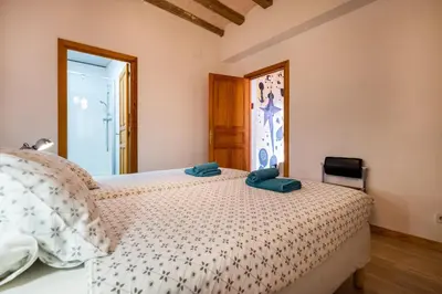 a bedroom with a bed with two towels on it at Apartamentos El Pintor in Barcelona