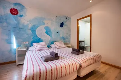 a bedroom with a bed with two towels on it at Apartamentos El Pintor in Barcelona