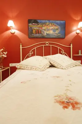 a bedroom with a white bed with red walls at Hostal Orleans in Barcelona