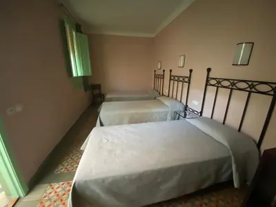 a room with two beds in a room at Hotel Peninsular in Barcelona
