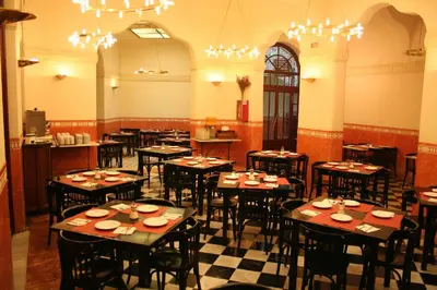 a restaurant with tables and chairs in a room at Hotel Peninsular in Barcelona