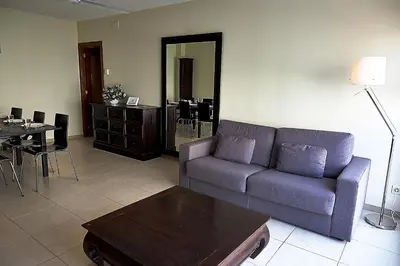 a living room with a couch and a table at Alguera Apartments Sant Andreu in Barcelona