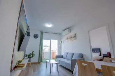 a living room with a blue couch and a table at Apartament Sagrada Familia in Barcelona