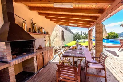an outdoor patio with a table and a fireplace at Catalunya Casas Stunning modern villa and just half hour to Barcelona! in Caldes de Montbui