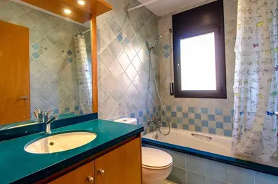 a bathroom with a sink and a toilet and a window at Catalunya Casas Stunning modern villa and just half hour to Barcelona! in Caldes de Montbui