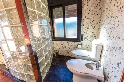 a bathroom with two toilets and a window at Catalunya Casas Stunning modern villa and just half hour to Barcelona! in Caldes de Montbui