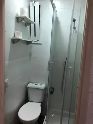 a bathroom with a toilet and a glass shower at Hostalin Barcelona Diputacion in Barcelona