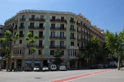 a large building with cars parked in front of it at Hostalin Barcelona Diputacion in Barcelona