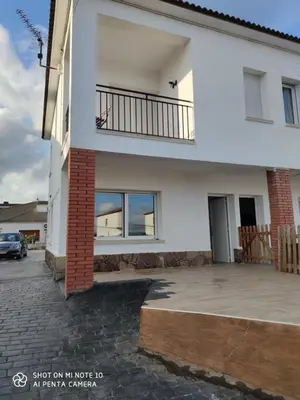 a white house with a balcony and a driveway at Estancia Rural Tranquila in Lliçà d'Amunt