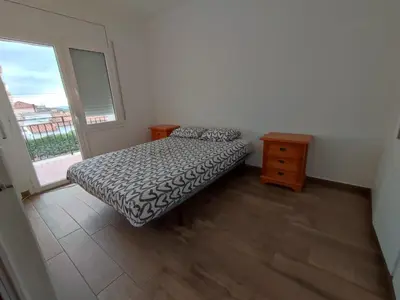 a small bedroom with a bed and a window at Estancia Rural Tranquila in Lliçà d'Amunt