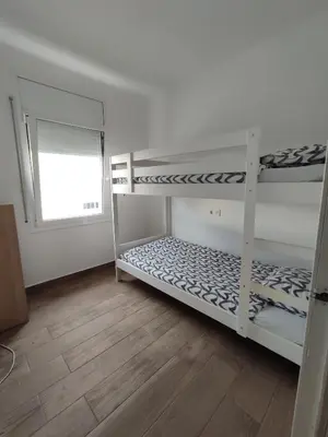 two bunk beds in a room with a window at Estancia Rural Tranquila in Lliçà d'Amunt