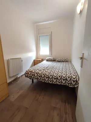a bedroom with a bed in a room with a window at Estancia Rural Tranquila in Lliçà d'Amunt
