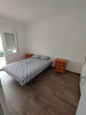 a bedroom with a bed and a wooden floor at Estancia Rural Tranquila in Lliçà d'Amunt