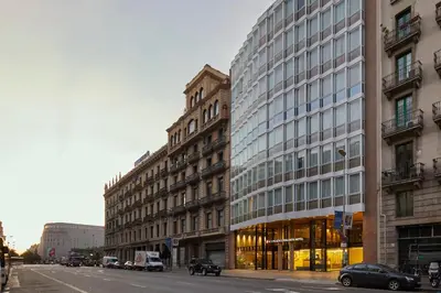 a building on a city street with cars parked in front at Dorma Plaza Catalunya in Barcelona