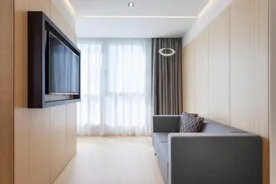 a living room with a couch and a flat screen tv at Dorma Plaza Catalunya in Barcelona