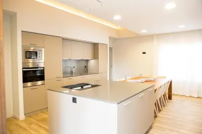 a kitchen with white cabinets and a white counter top at Can Cedre in Lliçà d'Amunt