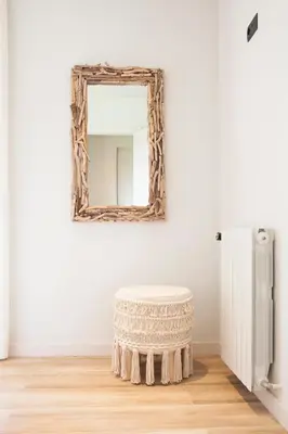 a mirror and a stool in a room at Can Cedre in Lliçà d'Amunt