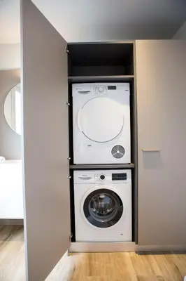 a laundry room with a washer and dryer at Can Cedre in Lliçà d'Amunt