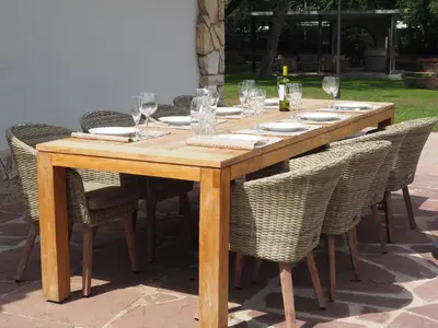 a wooden table with chairs and wine glasses on it at Can Cedre in Lliçà d'Amunt