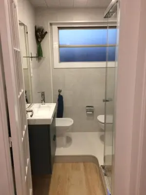 a bathroom with a sink and a toilet and a window at Pis Ocata in Masnou