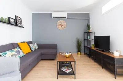 a living room with a couch and a tv at Lovely and Convenient Sagrada Familia Apartment in Barcelona