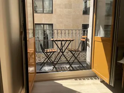 a balcony with a table and chairs on a building at Hostal la Palmera in Barcelona