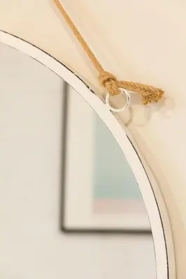 a tan hat with a rope on a wall at Novus Homes Barcelona Gracia in Barcelona