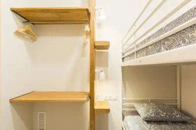a couple of bunk beds in a room with a bed at Novus Homes Barcelona Gracia in Barcelona