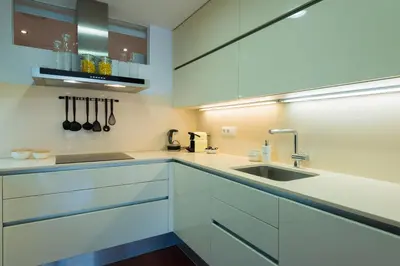 a kitchen with white cabinets and a sink at Petit Luxe l'Oasi d'Egara in Terrassa