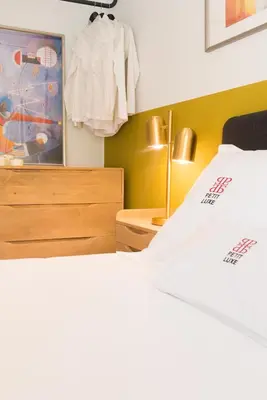 a bedroom with two beds and a dresser at Petit Luxe l'Oasi d'Egara in Terrassa