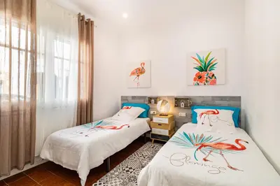 a room with two beds with drawings of birds on them at CASA FLAMINGO in Masnou