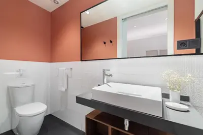 a bathroom with a white toilet and a sink at LeMar by Aspasios in Barcelona