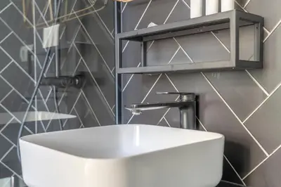 a bathroom with a white sink and a mirror at TSA La Rosa in Barcelona
