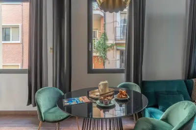 a living room with a table and chairs at TSA La Rosa in Barcelona
