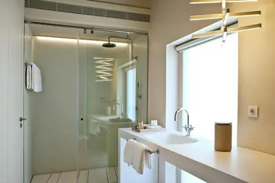 a bathroom with a large white tub and a sink at Mercer Hotel Barcelona in Barcelona