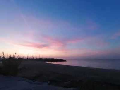 a sunset on a beach with the ocean at Hostal Santa Gemma in Sant Vicenç de Montalt