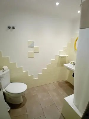 a bathroom with a toilet and a sink at Hostal Santa Gemma in Sant Vicenç de Montalt
