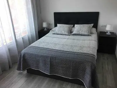 a bedroom with a large bed with two pillows at Apartment La Gavina Beach Barcelona Airport in Gavà
