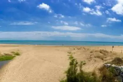 a sandy beach with the ocean in the background at Apartment La Gavina Beach Barcelona Airport in Gavà
