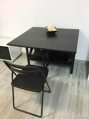a black table and a black chair in a room at Apartment La Gavina Beach Barcelona Airport in Gavà