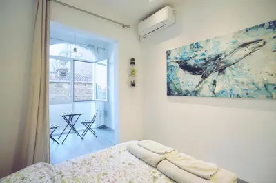 a bedroom with a bed and a painting on the wall at Dip2 in Barcelona