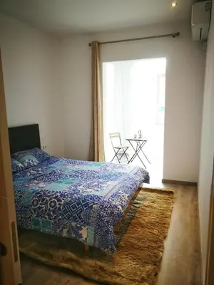 a bedroom with a bed with a blue comforter at Dip2 in Barcelona