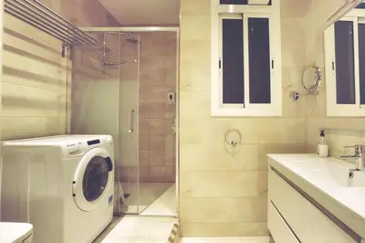 a bathroom with a washing machine and a shower at Dip2 in Barcelona