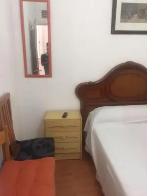 a bedroom with a bed and a dresser and a mirror at Pensión Teruel in Barcelona